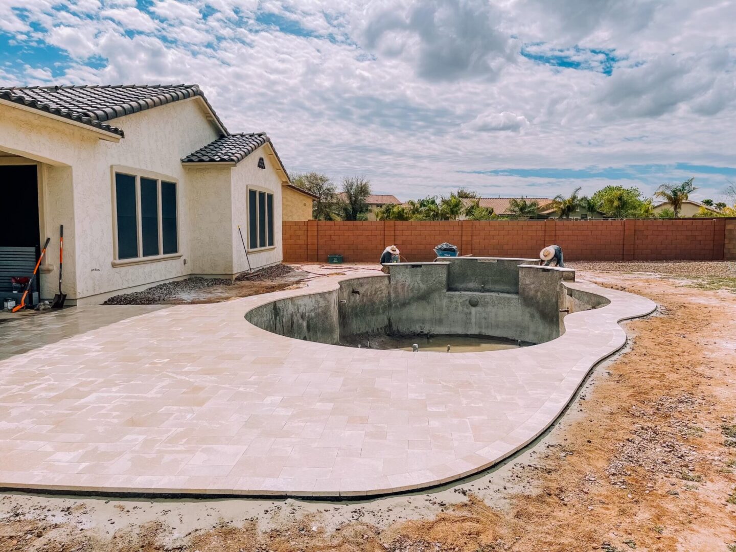 A swimming pool is being built in a backyard.