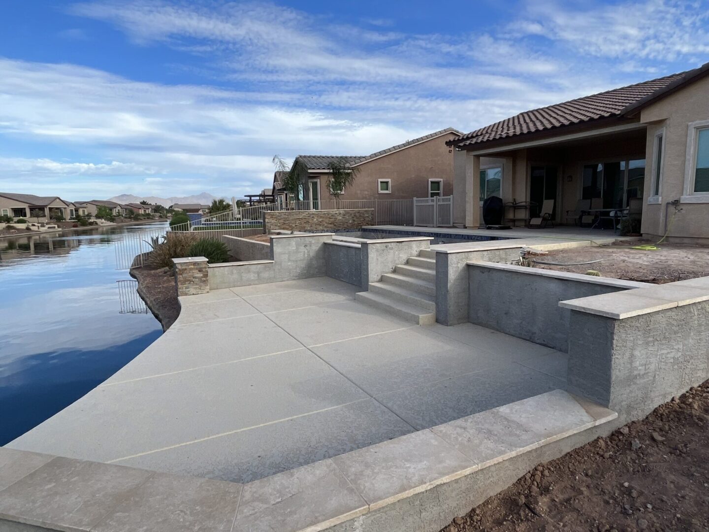 A concrete patio next to a waterway in arizona.